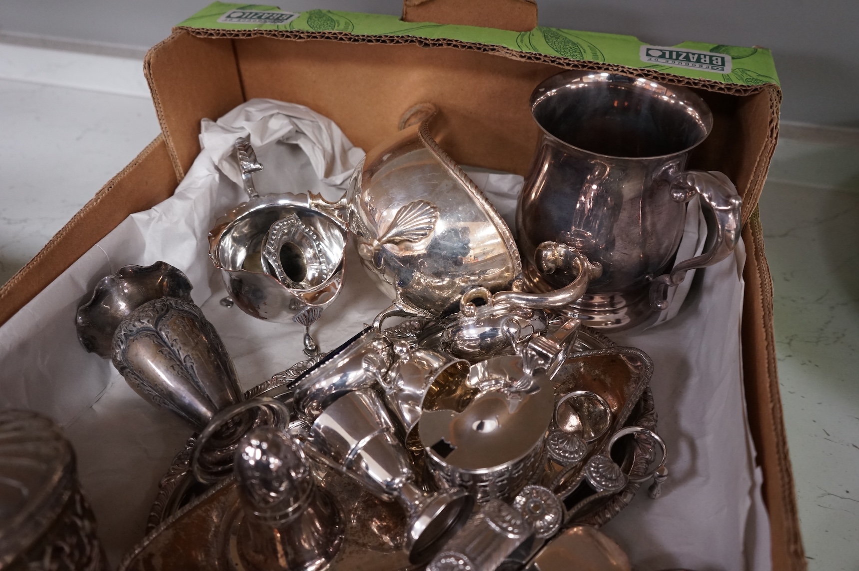 A collection of small plated wares including a pair of candle sticks, cruets, cutlery, sugar shaker, etc